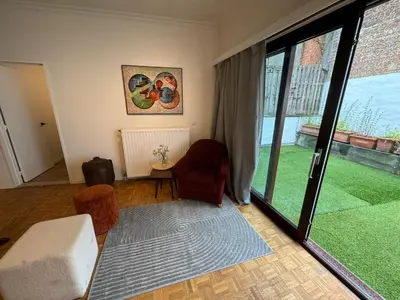 a living room with a large sliding glass door at Garden loft in city center Meir 1FL in Antwerp