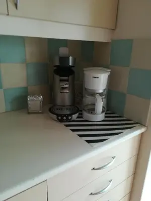 a kitchen with a coffee maker on a counter at Apparts Chez Odak in Brussels
