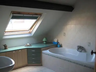 a bathroom with a large tub and a window at Apparts Chez Odak in Brussels