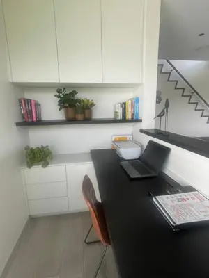 a kitchen with a black table with a laptop on it at Villa Flandre in Berlare