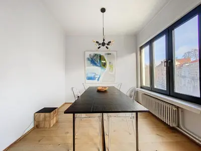 a dining room with a table and two chairs at Churchill - Brugmann square in Brussels