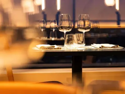 three glasses of wine sitting on a table at Mövenpick Hotel Brussels Airport in Zaventem