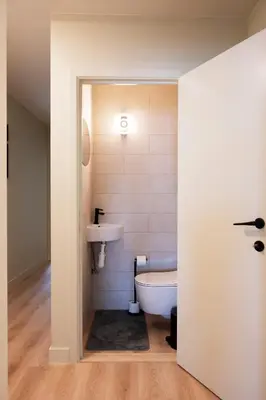 a bathroom with a tub and a sink and a toilet at Charlemagne in Mechelen