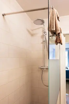a shower with a glass door in a bathroom at Charlemagne in Mechelen