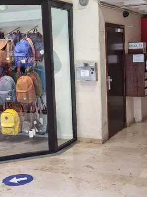 a door to a store with a display of bags at Charlemagne in Mechelen