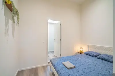 a bedroom with a blue bed and a mirror at Cozy Antwerp City Apartments in Antwerp