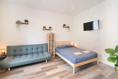 a living room with a couch and a bed at Cozy Antwerp City Apartments in Antwerp