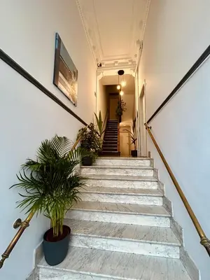 a staircase in a building with potted plants at European District Apartment Zero in Brussels