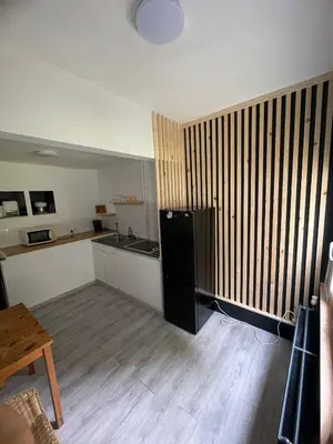 a kitchen with a black refrigerator in a room at European District Apartment Zero in Brussels