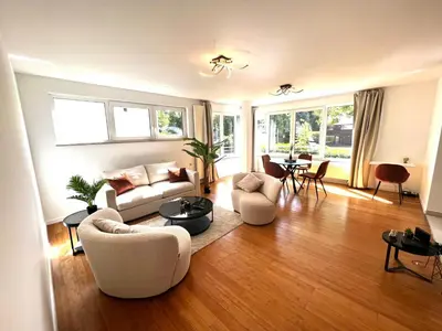 a living room with a couch and chairs and a table at Wolu suites in Brussels