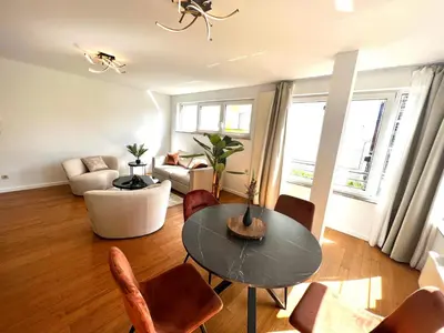a living room with a table and chairs at Wolu suites in Brussels
