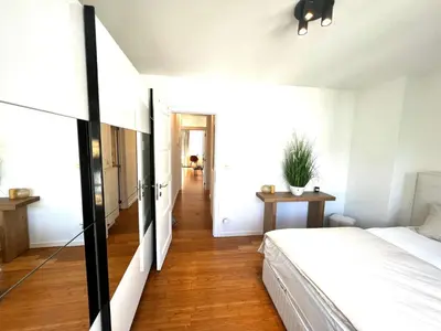 a bedroom with a bed and a hallway at Wolu suites in Brussels