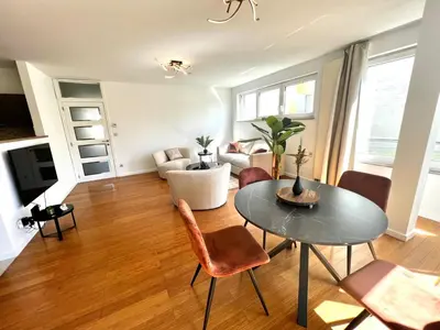 a living room with a table and a couch at Wolu suites in Brussels