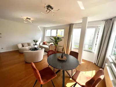 a living room with a table and chairs at Wolu suites in Brussels