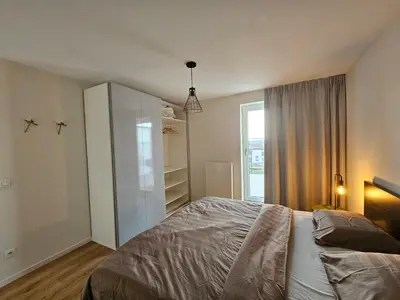 a bedroom with a bed and a closet at Penthouse with big terrace in Vilvoorde