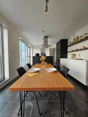 a dining room with a wooden table and chairs at Penthouse with big terrace in Vilvoorde