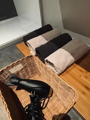 two towels and a hair dryer sitting on the floor at Penthouse with big terrace in Vilvoorde