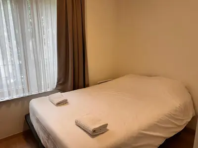 a bedroom with a bed with two towels on it at Cosy 2 Bedroom Apartment in City Center in Brussels