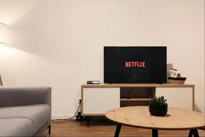 a living room with a tv on a table at Cosy 2 Bedroom Apartment in City Center in Brussels
