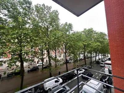 a view of a city street with cars parked on the road at Cosy 2 Bedroom Apartment in City Center in Brussels