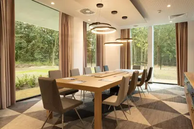 a conference room with a wooden table and chairs at Holiday Inn Express Brussels - Airport by IHG in Diegem