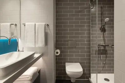 a bathroom with a sink and a toilet and a shower at Holiday Inn Express Brussels - Airport by IHG in Diegem