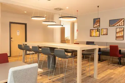 a dining room with a table and chairs at Holiday Inn Express Brussels - Airport by IHG in Diegem