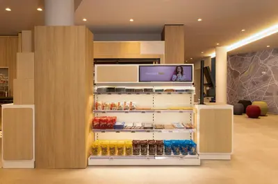 a refrigerator filled with lots of drinks in a store at Holiday Inn Express Brussels - Airport by IHG in Diegem