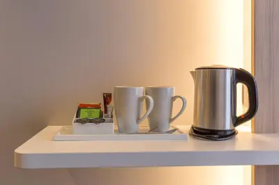 two coffee cups on a shelf in a room at Holiday Inn Express Brussels - Airport by IHG in Diegem