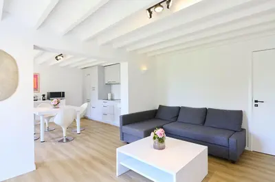 a living room with a couch and a table at Le cottage de la Verte Voie in Wavre