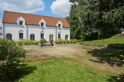 a large white house with a red roof at Le cottage de la Verte Voie in Wavre