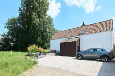 a car parked in front of a garage at Le cottage de la Verte Voie in Wavre