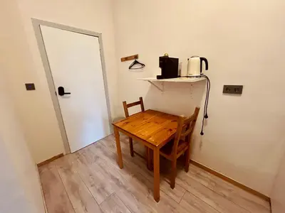 a room with a wooden table with a coffee maker on it at European District Apartment Eleven in Brussels