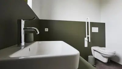 a bathroom with a white sink and a toilet at Vakantiewoning Het Kasterhuis in Wetteren