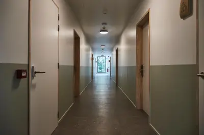 an empty hallway with green and white walls at Vakantiewoning Het Kasterhuis in Wetteren