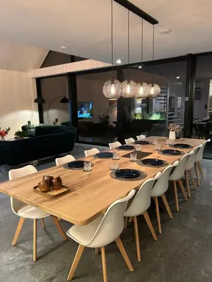 a large wooden table and chairs in a living room at De Krekelberg in Brecht