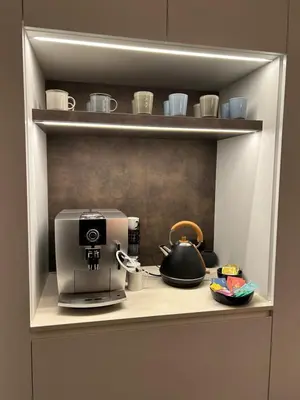 a cupboard with a coffee maker and a coffeemaker at De Krekelberg in Brecht