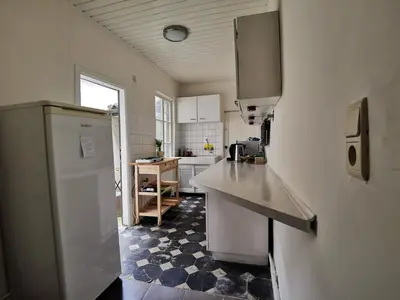 a kitchen with a sink and a refrigerator at Spacious room in city centre in Ghent