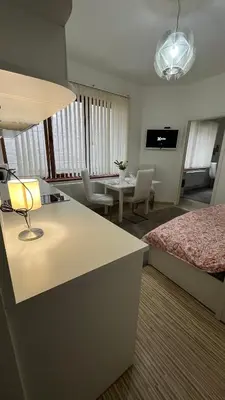 a hotel room with a bed and a living room at Two bedroom flat - Hyper Center Brussels in Brussels