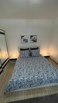 a bed in a bedroom with two pictures on the wall at Two bedroom flat - Hyper Center Brussels in Brussels
