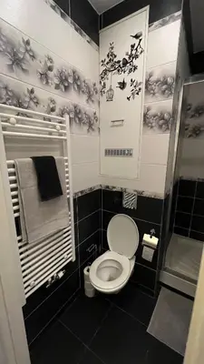 a black and white bathroom with a toilet and towels at Two bedroom flat - Hyper Center Brussels in Brussels