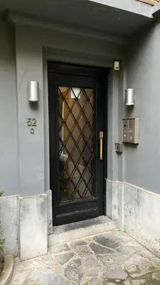 a black door with a window on a building at Two bedroom flat - Hyper Center Brussels in Brussels