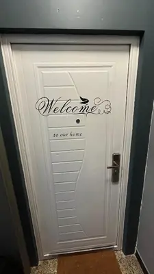 a white door with a welcome to our home sign on it at Two bedroom flat - Hyper Center Brussels in Brussels