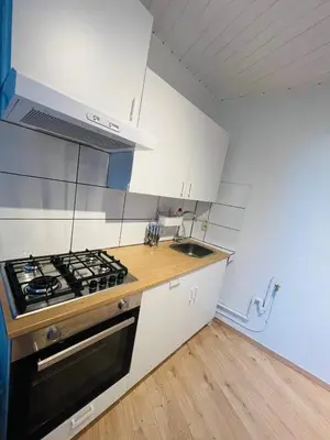a kitchen with white cabinets and a stove top oven at Heart of Antwerp in Antwerp