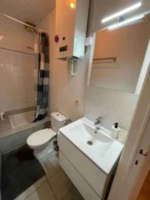 a bathroom with a white sink and a toilet at Heart of Antwerp in Antwerp