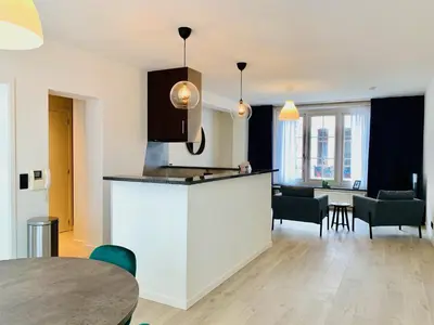 a kitchen and living room with a table and chairs at Belfort Shortstay in Ghent