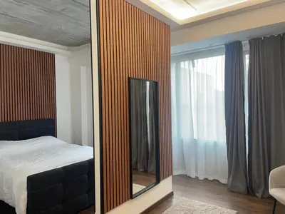 a mirror in a bedroom with a bed and a window at Boutique Diamond Apartments in Antwerp