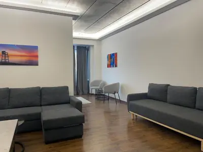a living room with a couch and a table at Boutique Diamond Apartments in Antwerp