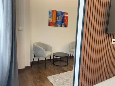 a room with two chairs and a table and a painting at Boutique Diamond Apartments in Antwerp