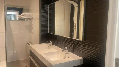 a bathroom with two sinks and a mirror at Boutique Diamond Apartments in Antwerp